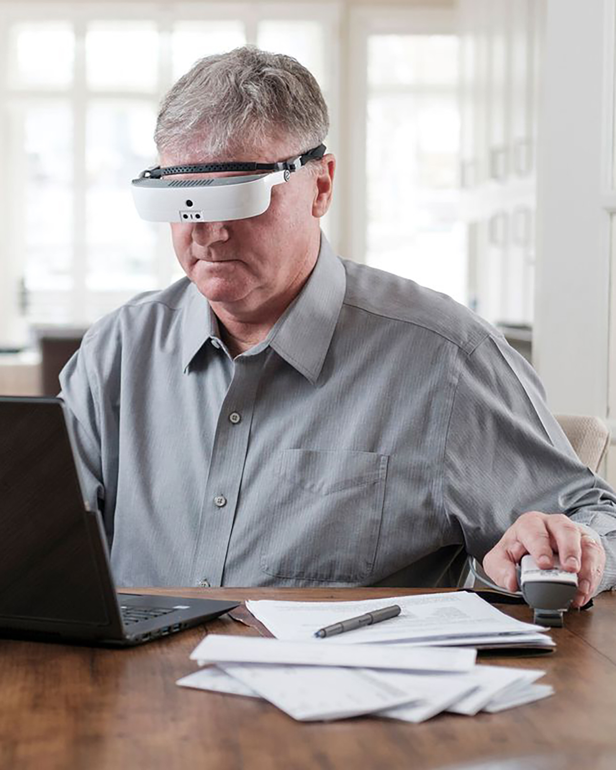 Man using head mounted magnifier